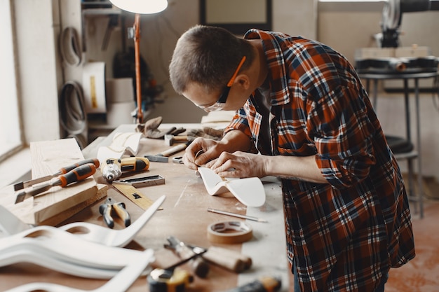 Craftsman cutting a wooden plank