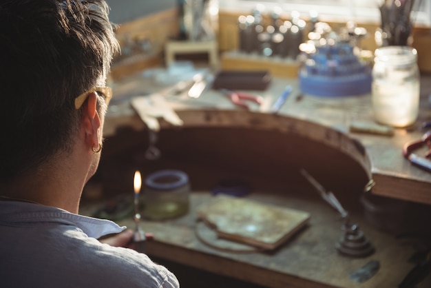 Free Photo craftswoman holding blow torch