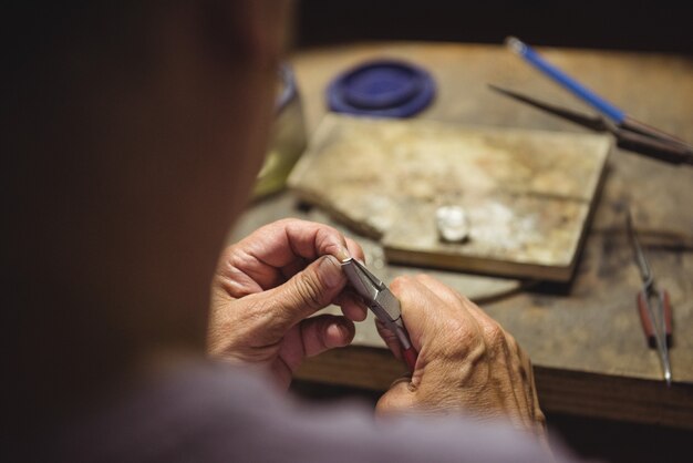 Craftswoman using pliers