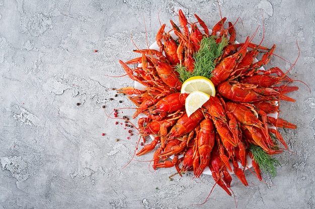 Free photo crayfish. red boiled crawfishes on table in rustic style, closeup. lobster closeup. border desig. top view