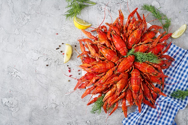 Free photo crayfish. red boiled crawfishes on table in rustic style, closeup. lobster closeup. border desig. top view