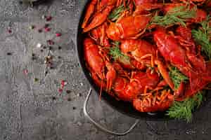 Free photo crayfish. red boiled crawfishes on table in rustic style, closeup. lobster closeup. border design. top view. flat lay.