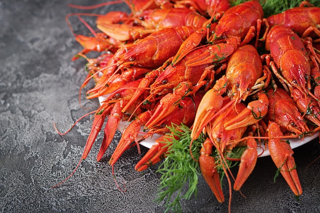 Free photo crayfish. red boiled crawfishes on table in rustic style, closeup. lobster closeup. border design