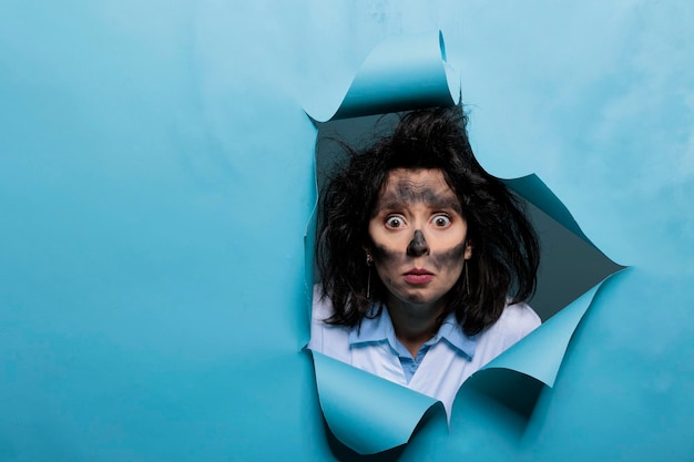 Free photo crazy foolish biochemist with funny expressions, dirty face and messy hair after failed laboratory experiment. lunatic scientist looking dumb and amusing after toxic chemical explosion. studio shot.