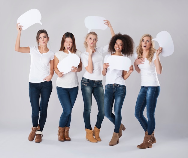 Free photo crazy girls holding empty speech bubble