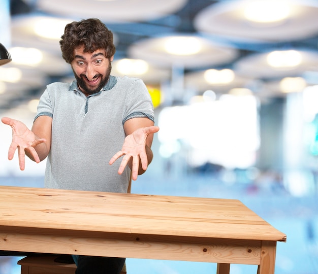 Free photo crazy young man with table .happy expression