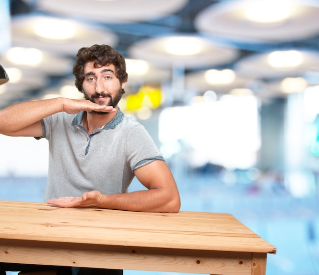 crazy young man with table .happy expression