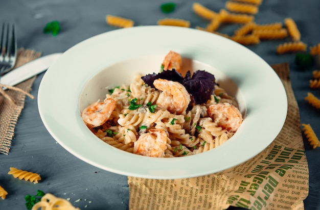 creamy fusilli pasta with fried shrimps and fresh herbs