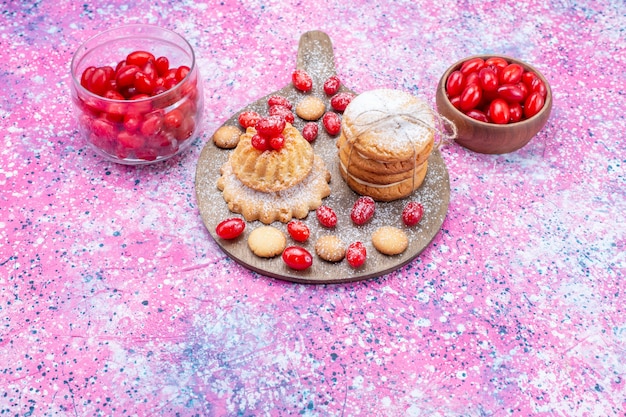 creamy sandwich cookies with red fresh dogwoods on bright, cookie cake biscuit sour fruit berry