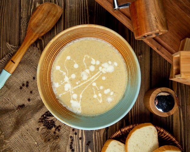 Creamy soup and wooden spoon