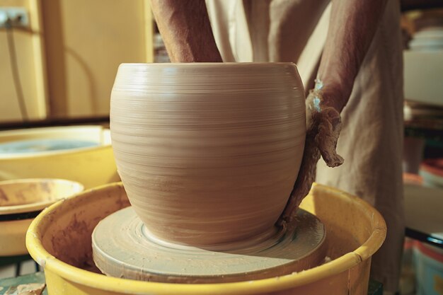 Creating a jar or vase of white clay close-up. Master crock.