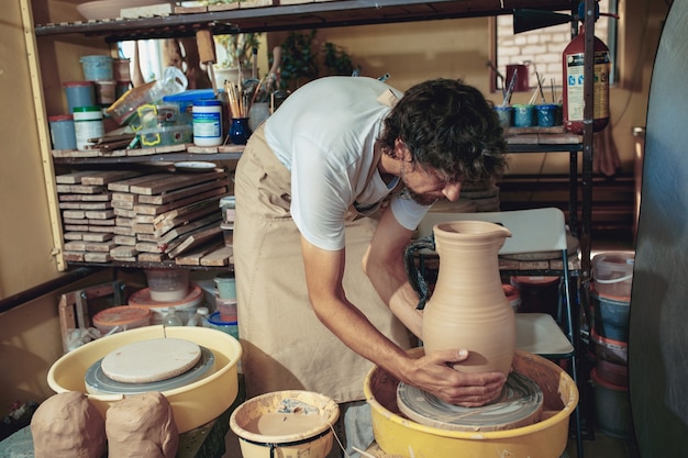 Creating a jar or vase of white clay close-up. Master crock.