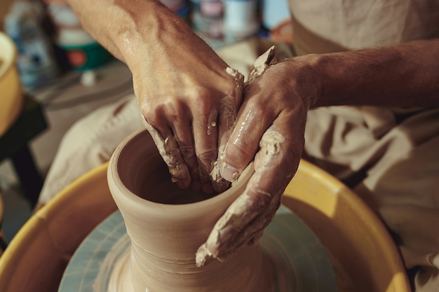 Creating a jar or vase of white clay close-up. Master crock.