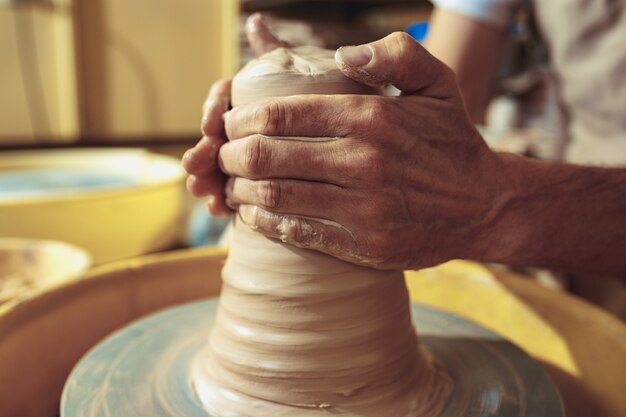 Creating a jar or vase of white clay close-up. Master crock.