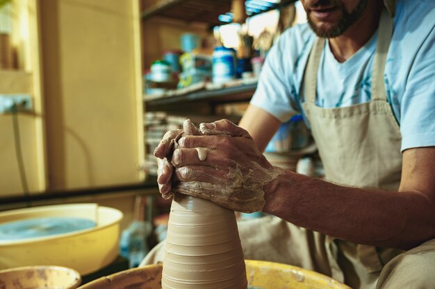 Creating a jar or vase of white clay close-up. Master crock.