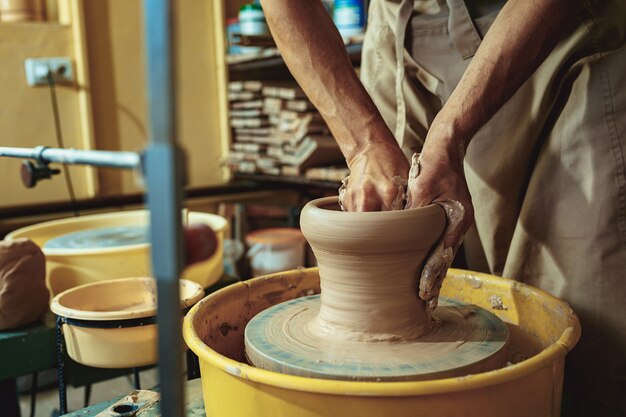 Creating a jar or vase of white clay close-up