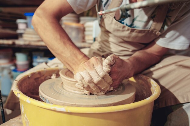 Creating a jar or vase of white clay close-up