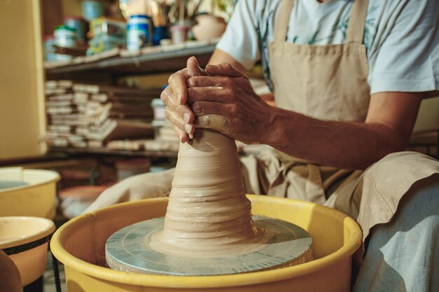 Creating a jar or vase of white clay close-up.