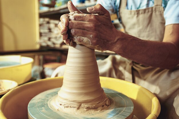 Creating a jar or vase of white clay close-up.