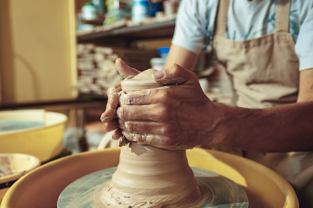 Creating a jar or vase of white clay close-up.