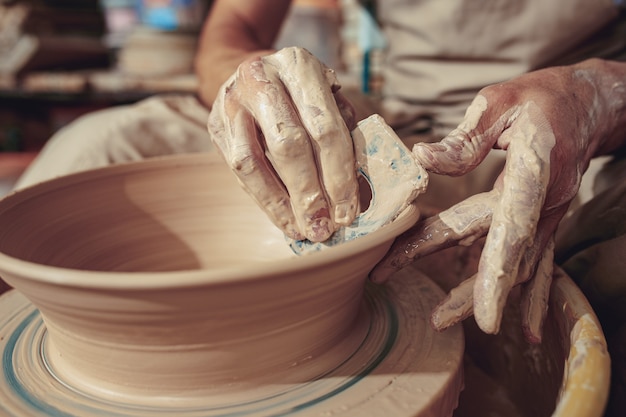 Creating a jar or vase of white clay close-up.