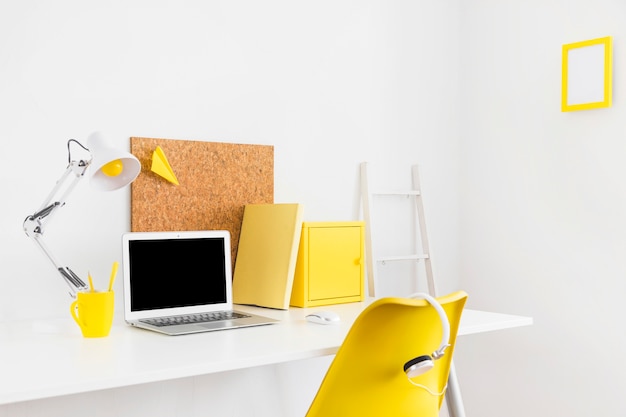 Free Photo creative bright workspace with yellow details and cork board