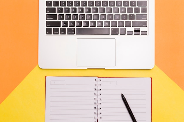 Free Photo creative flat lay of workplace desk with orange and yellow background 