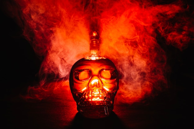 Free photo creative skull-shaped bottle in smoke