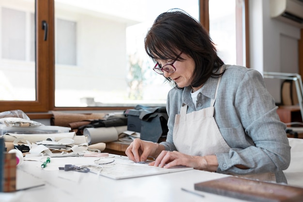 Creative tailor working in workshop on a new cloth