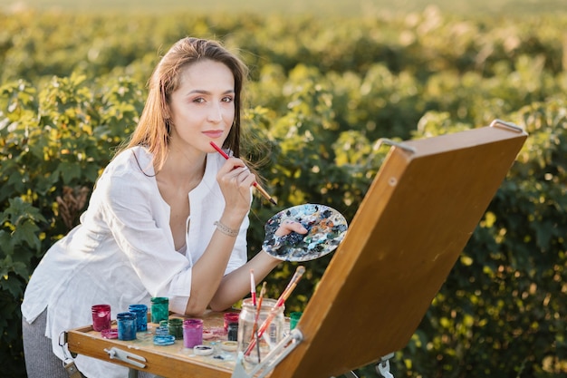 Creative woman in the nature painting