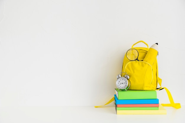 Creative workspace with yellow backpack and notebooks