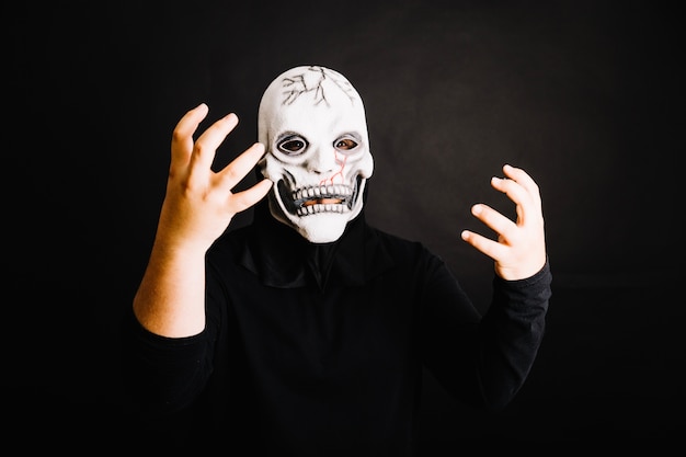 Creepy man posing in mask