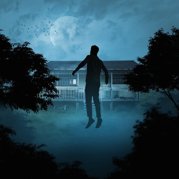 Creepy scene with man floating outside house