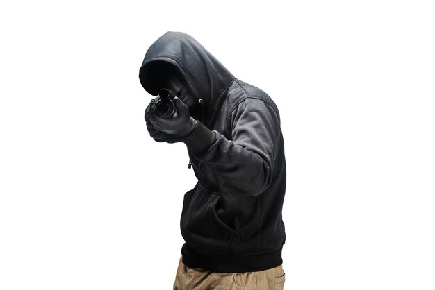 Criminal man in hidden mask pointing the shotgun isolated over white background