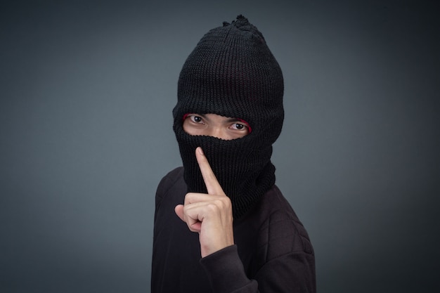 Free photo criminals wear a mask in black on gray