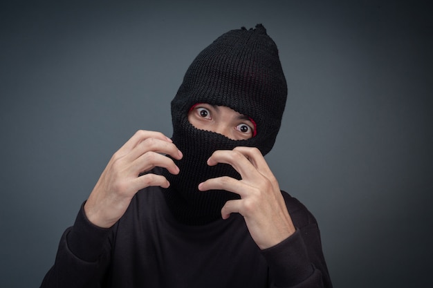 Free photo criminals wear a mask in black on gray