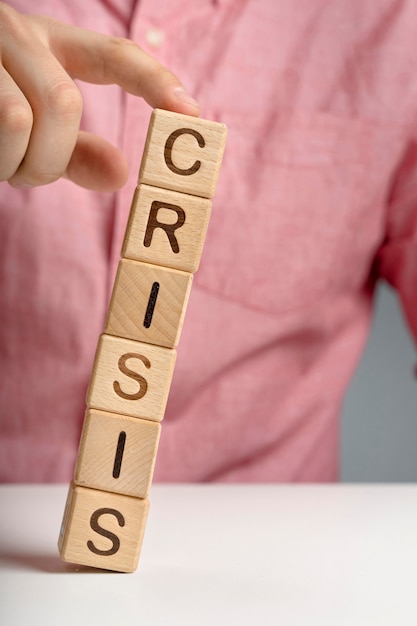 Crisis mesage on wooden blocks falling