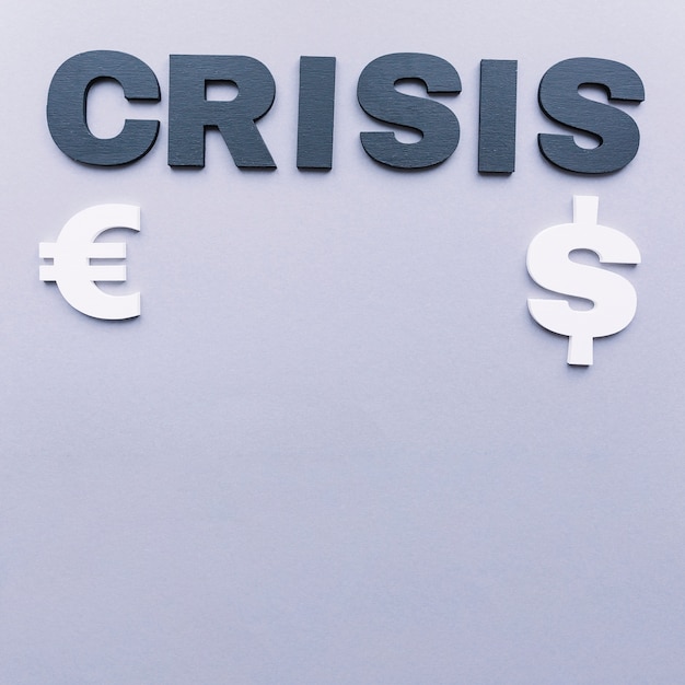 Free photo crisis word with euro and dollar symbol on grey background