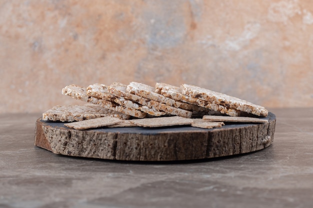 Crispbread and puffed rice cakes in tray , on the marble surface