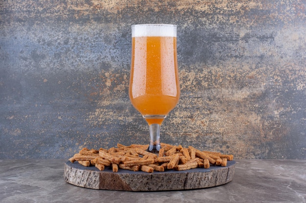 Crispy crackers with beer on wood piece