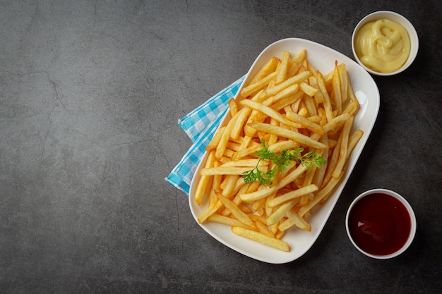 Crispy French fries with ketchup and mayonnaise.