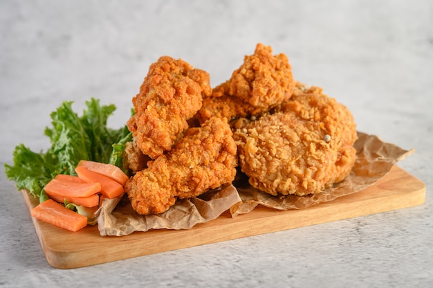 Crispy fried chicken on a wooden cutting board