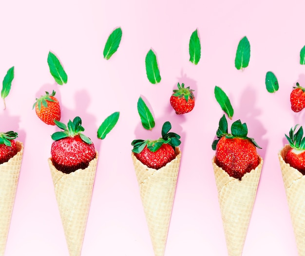 Free Photo crispy ice cream cones with strawberry on light surface