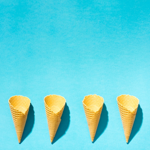 Free photo crispy ice cream wafers horns on colorful background