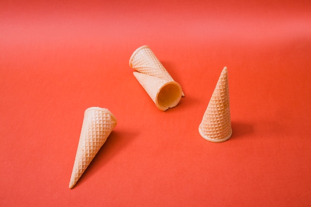 Free photo crispy ice cream wafers horns on red background