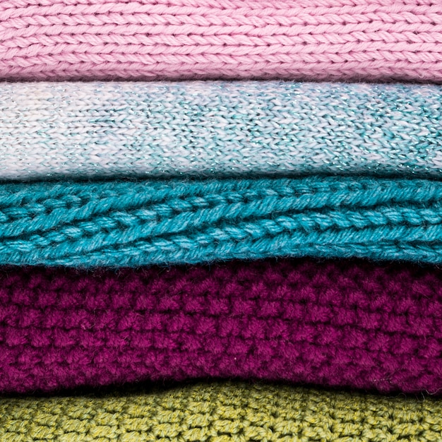 Free photo crocheted colorful wool clothes stacked