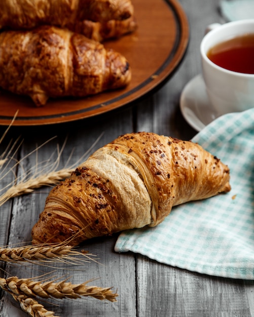 croissant with cup of teon table