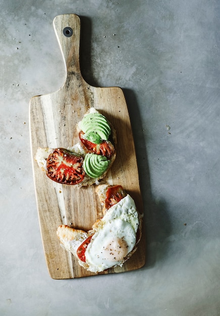 Croissant with heirloom tomato, avocado, and a fried egg