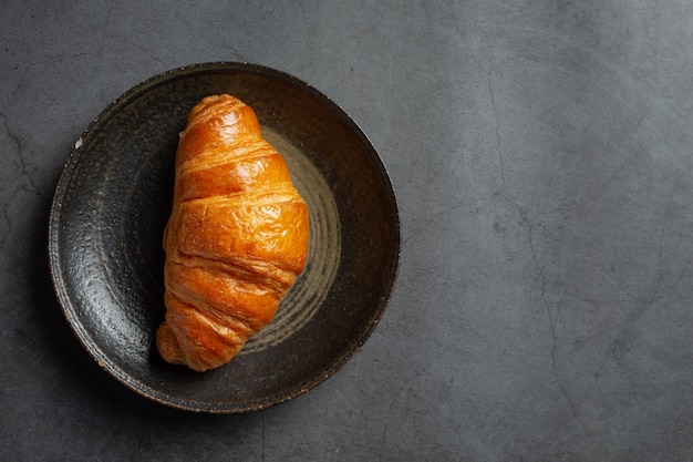 Croissants on black background.