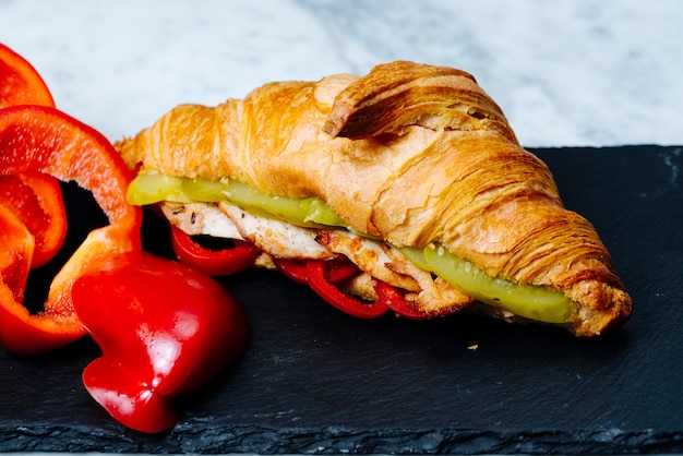 croissants filled with fried chicken slices and pickles